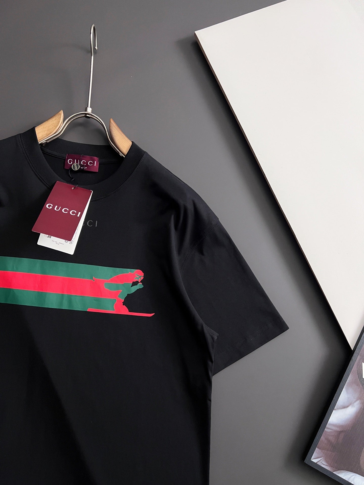 Black short-sleeve T-shirt with multicolor stripe and green Puma graphic