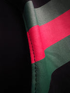 Black fabric with red and green diagonal stripe detail