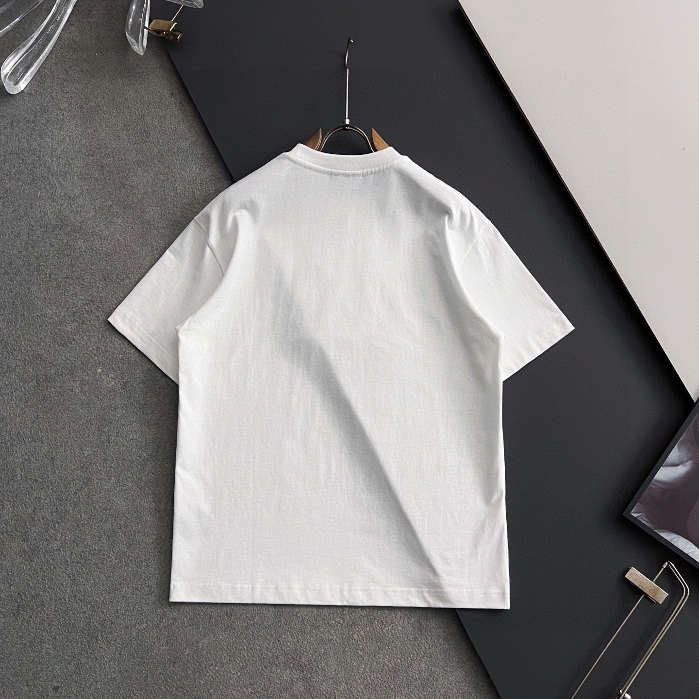 White short-sleeve T-shirt back view on hanger, plain design