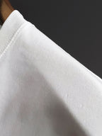 White short-sleeve T-shirt fabric close-up, smooth cotton weave