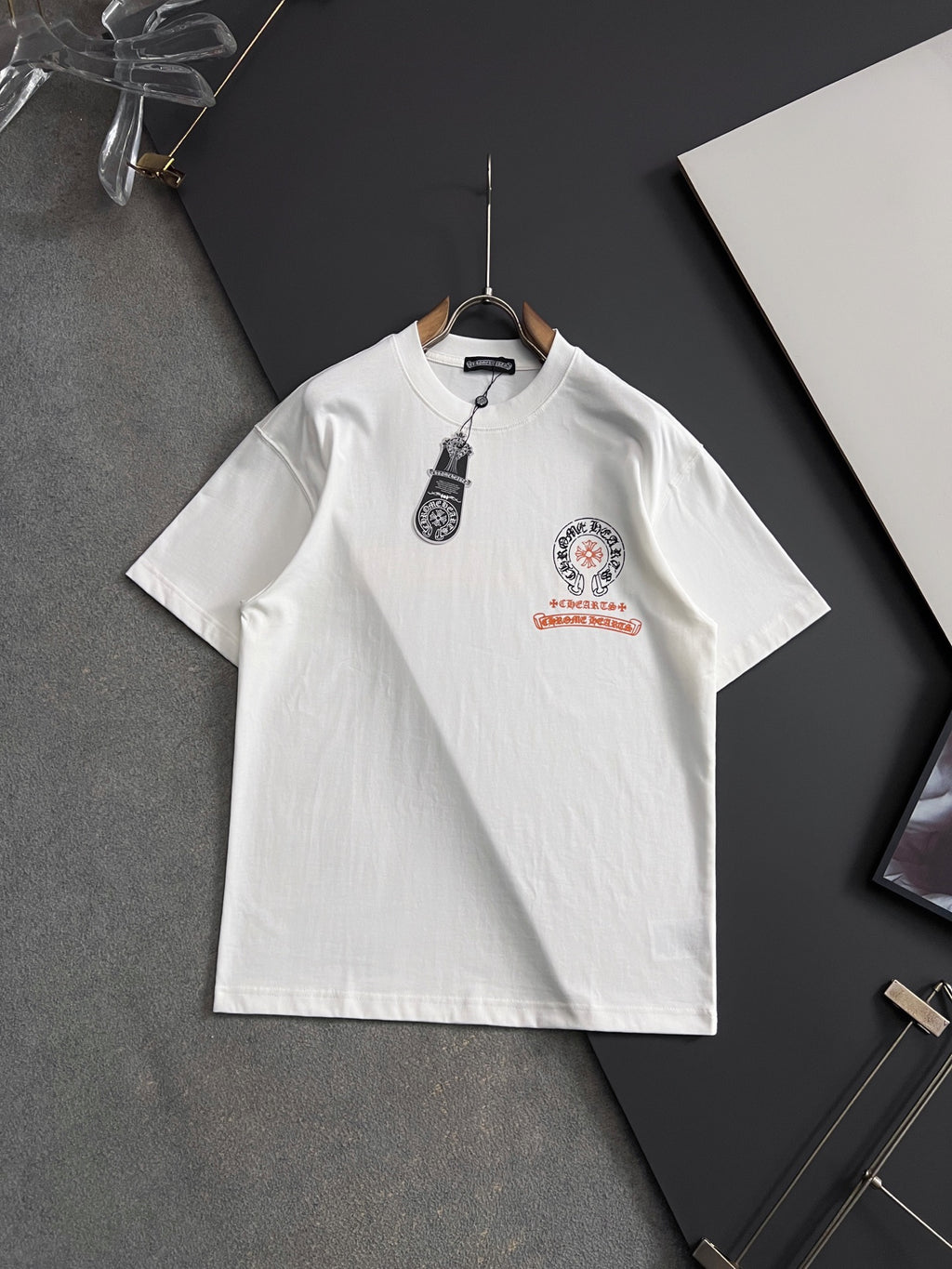 White short-sleeve T-shirt with front crest graphic and red accent print
