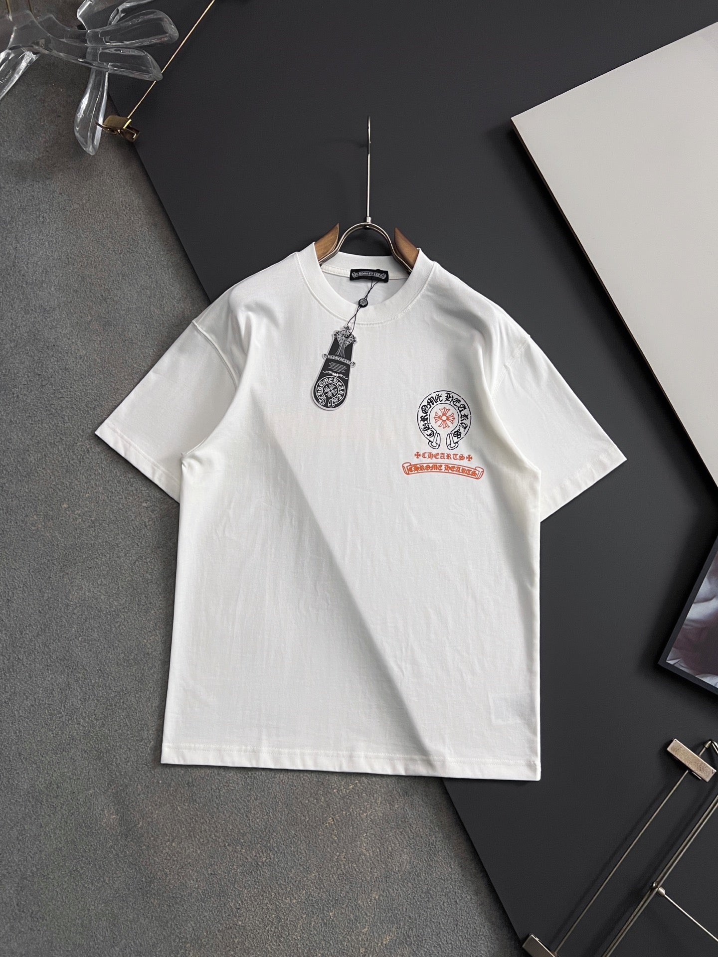 White short-sleeve T-shirt with front crest graphic and red accent print