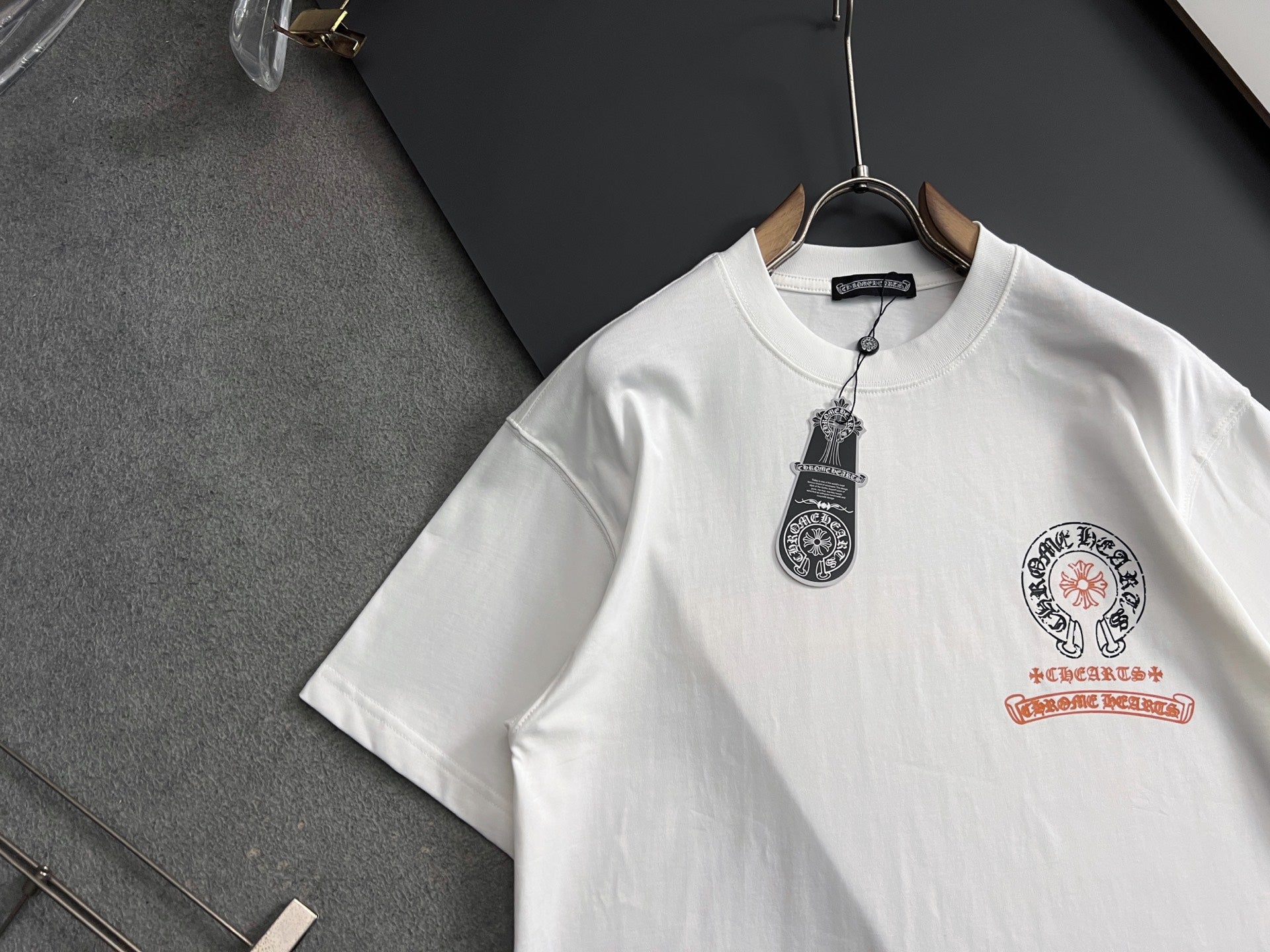 White short-sleeve T-shirt close view of neckline and crest patch print
