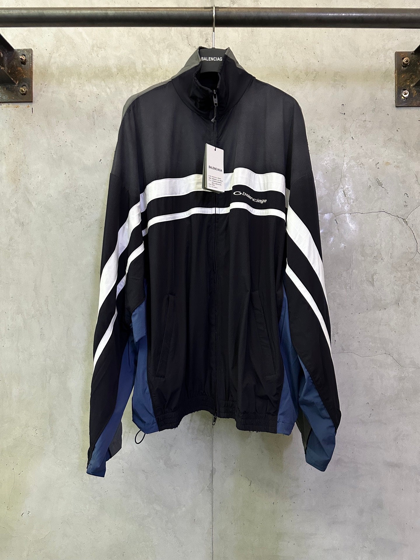 Balenciaga zip jacket with white wave stripes, black body, blue side panels