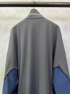 Balenciaga zip jacket back view, dark gray with blue panels at elbows