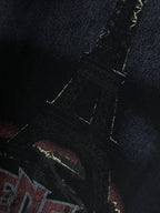 Graphic T-shirt close-up, band-style letters in red and blue with yellow accents