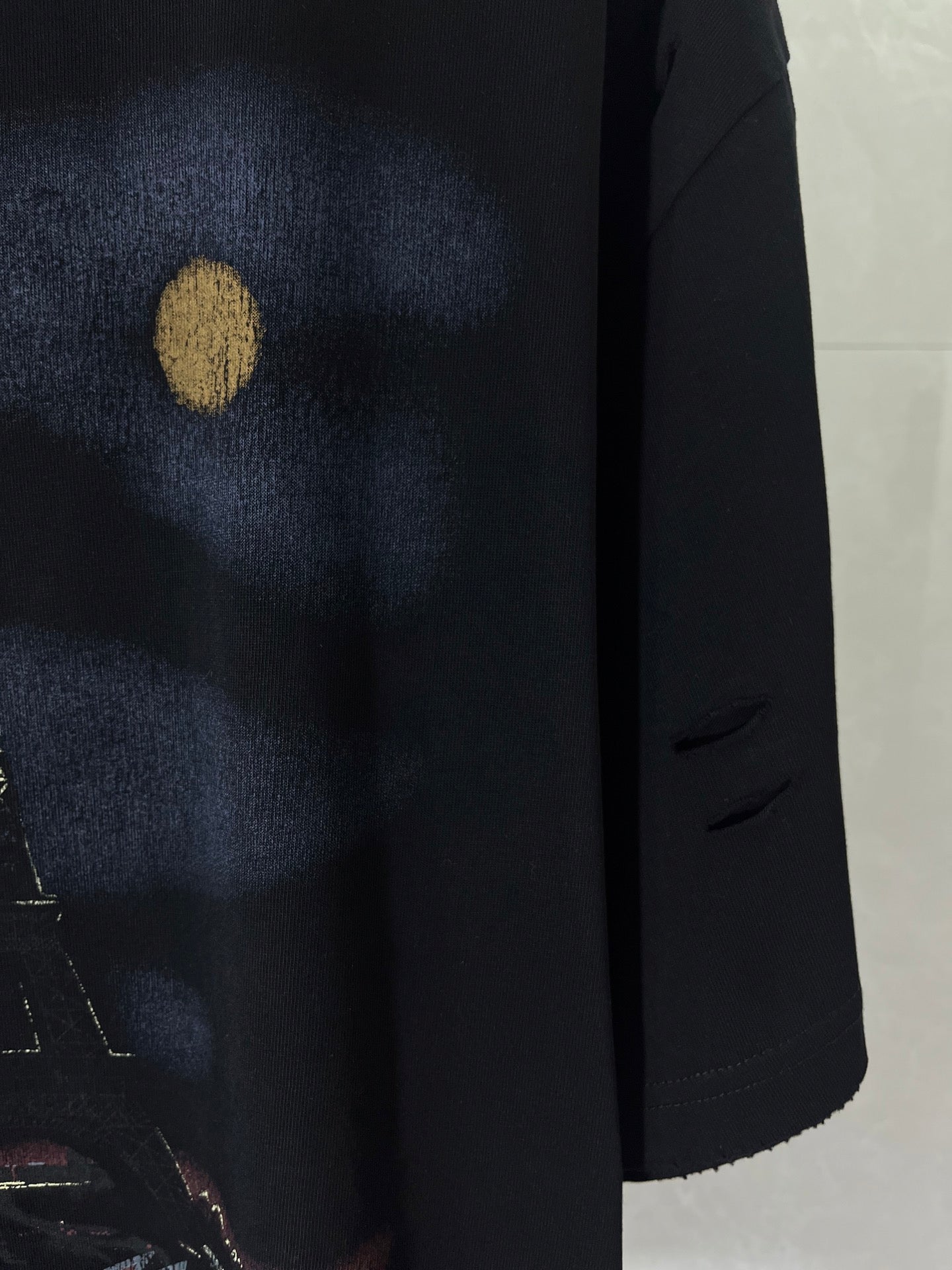 Graphic T-shirt, dark navy close-up of front artwork with gold spot