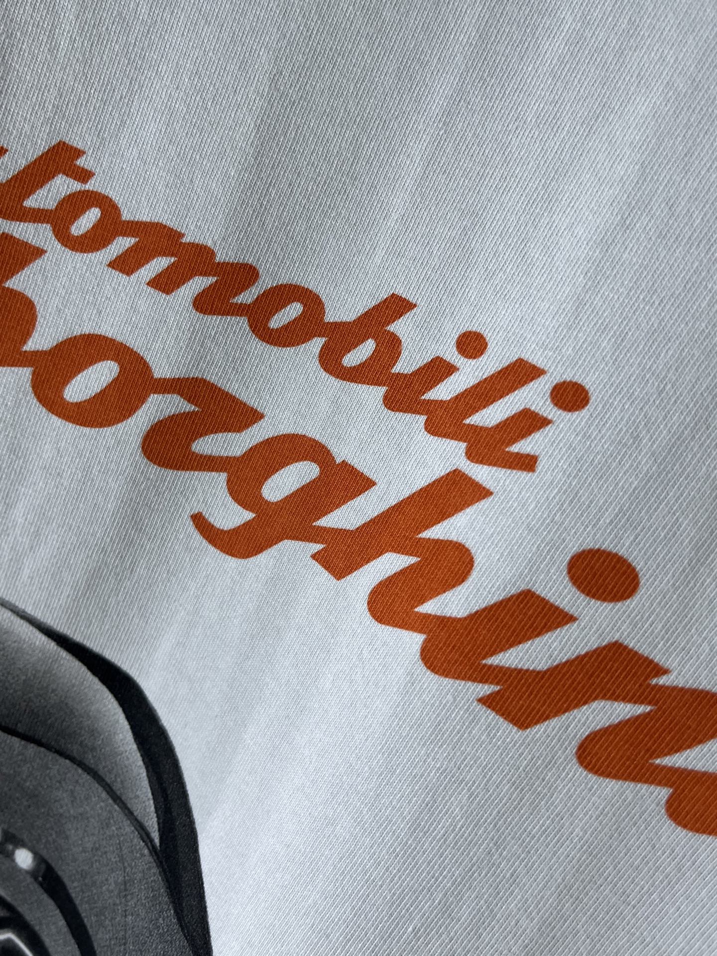 Light blue T-shirt with orange Lamborghini script-style text