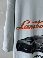 Light blue T-shirt sleeve with partial Lamborghini script and car graphic
