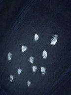 Navy T-shirt fabric with scattered white speckle marks