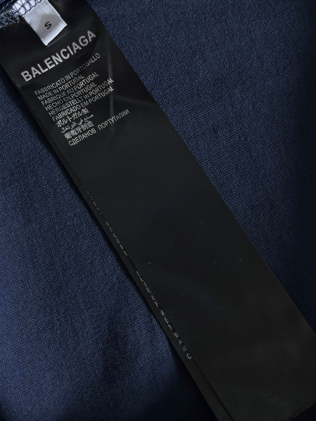 Navy T-shirt with black interior care label and stitched side hem