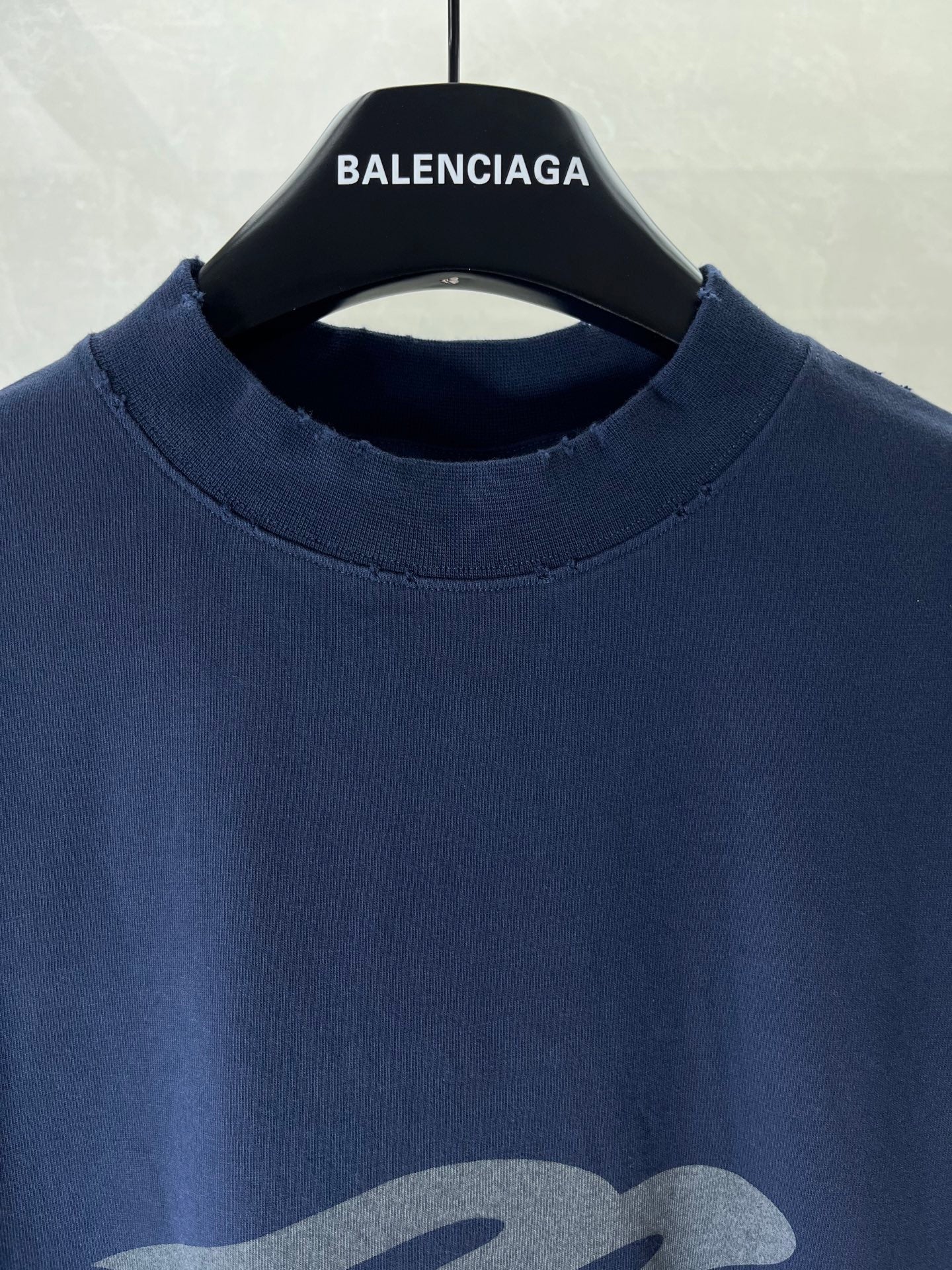Navy crew-neck T-shirt with ribbed collar and BALENCIAGA text at neckline