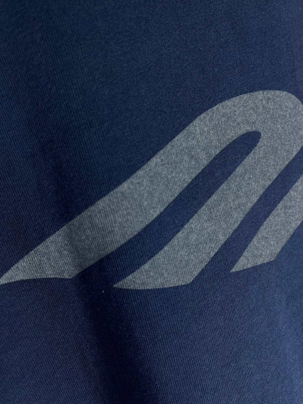 Navy T-shirt showing grey graphic close-up