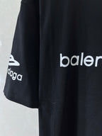Dark navy T-shirt side view with 'balenciaga' logo sleeve print
