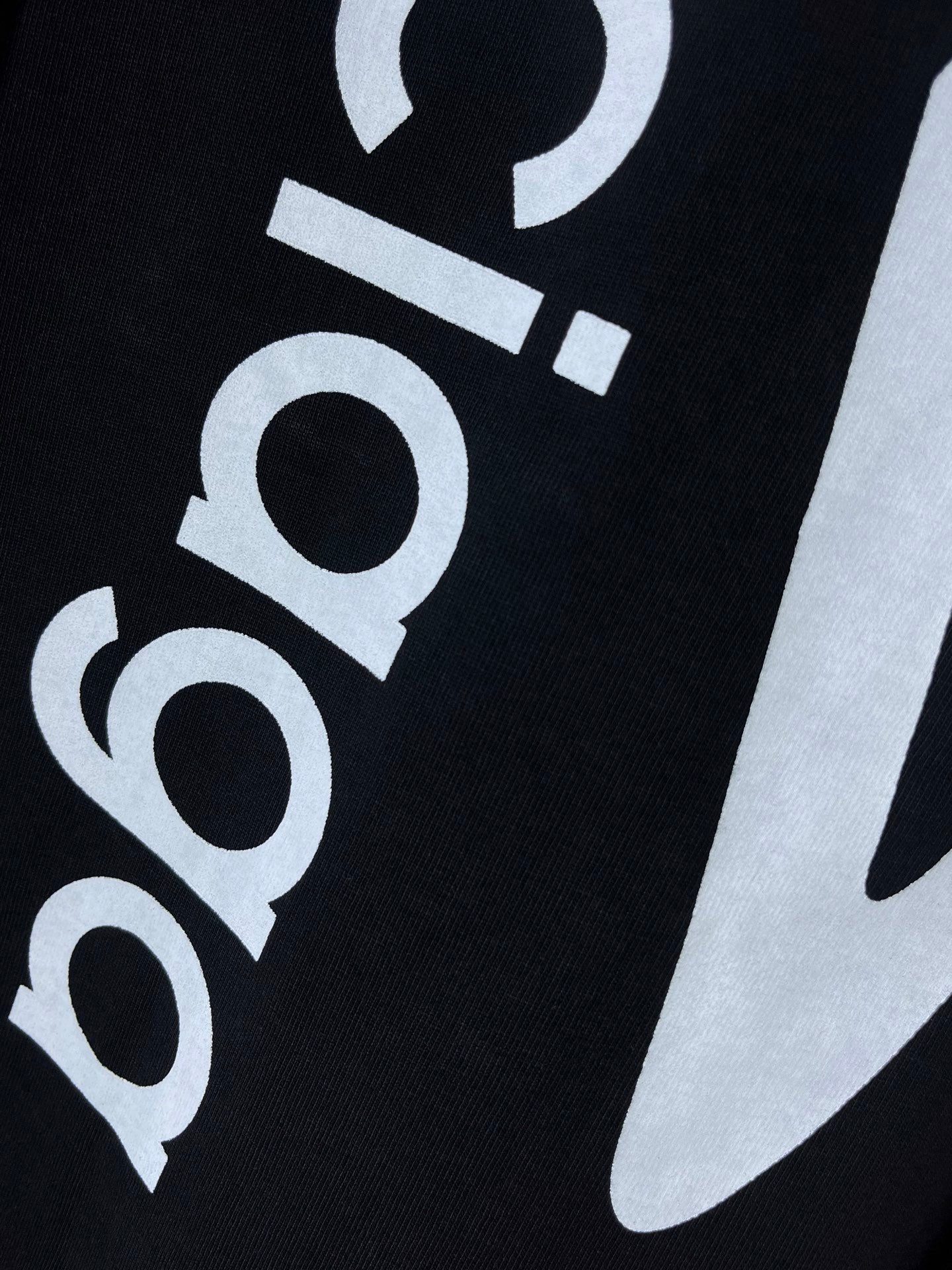 Dark navy T-shirt close-up of 'balenciaga' and large swoosh graphic