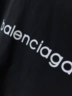 Dark navy T-shirt fabric close-up with 'balenciaga' wordmark