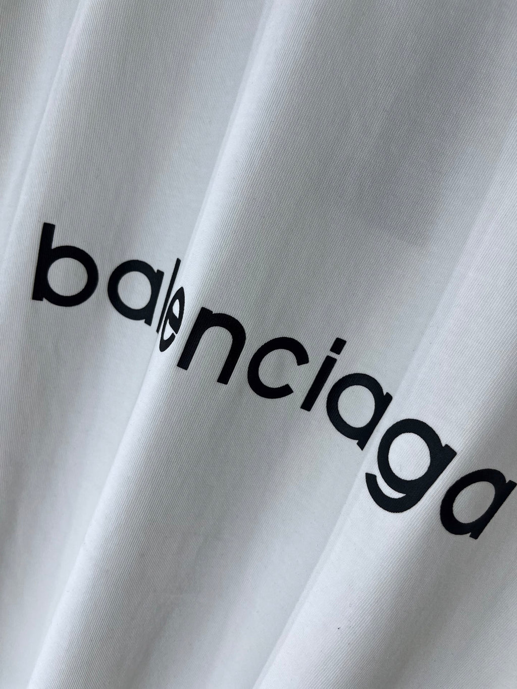 White T-shirt with large Balenciaga wordmark print across the fabric