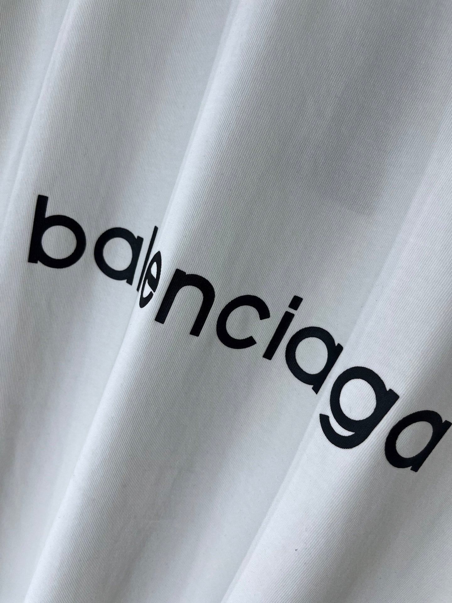 White T-shirt with large Balenciaga wordmark print across the fabric