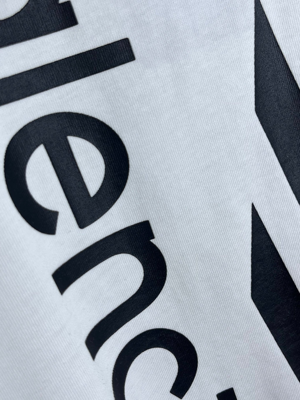 White T-shirt with partial Balenciaga circular symbol graphic in black