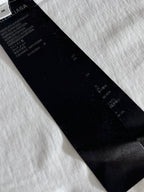 Black interior care label on white T-shirt near the collar
