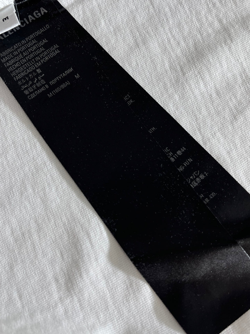 Balenciaga black fabric neck label on a white T-shirt