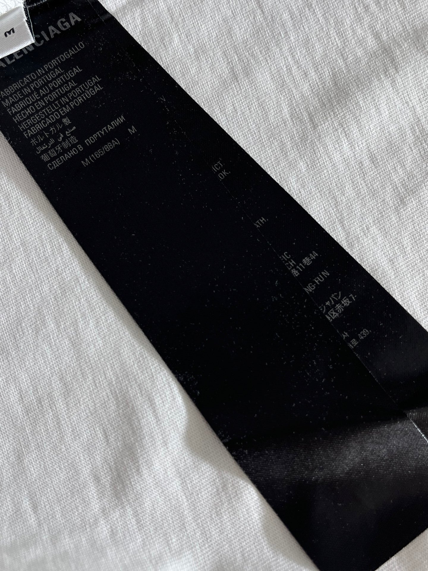 Balenciaga black fabric neck label on a white T-shirt
