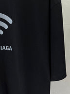 Black T-shirt sleeve detail with white Wi‑Fi icon and partial BALENCIAGA text