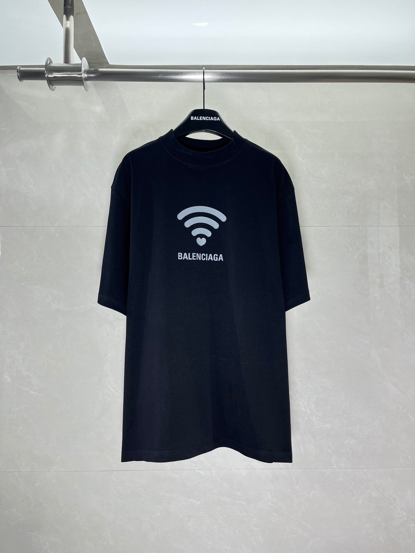 Black short-sleeve T-shirt with white Wi‑Fi logo and BALENCIAGA text
