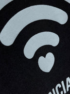 Black T-shirt close-up of large white Wi‑Fi icon with small heart detail