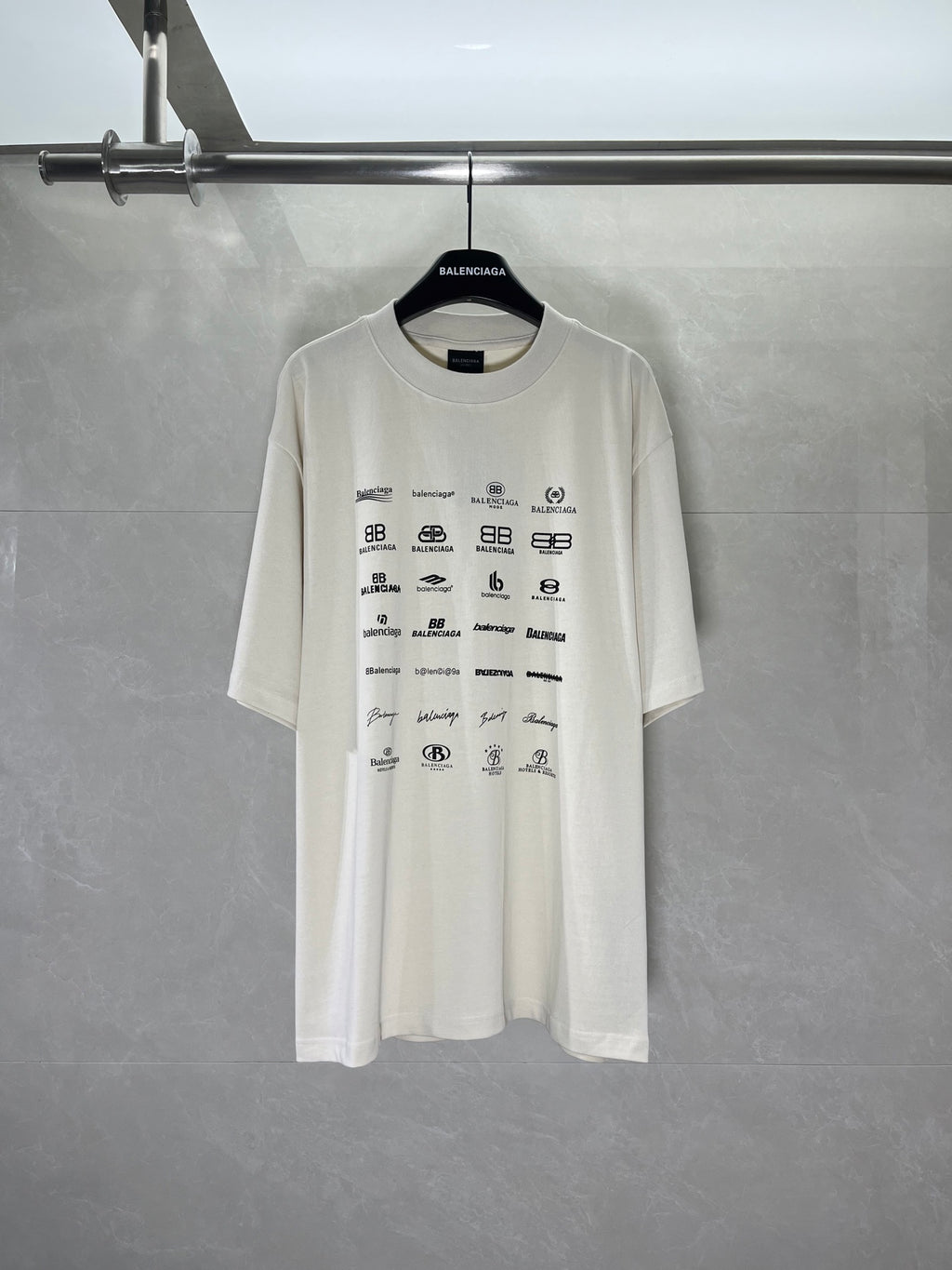 White short-sleeve T-shirt with all-over Balenciaga logo and icon print on front