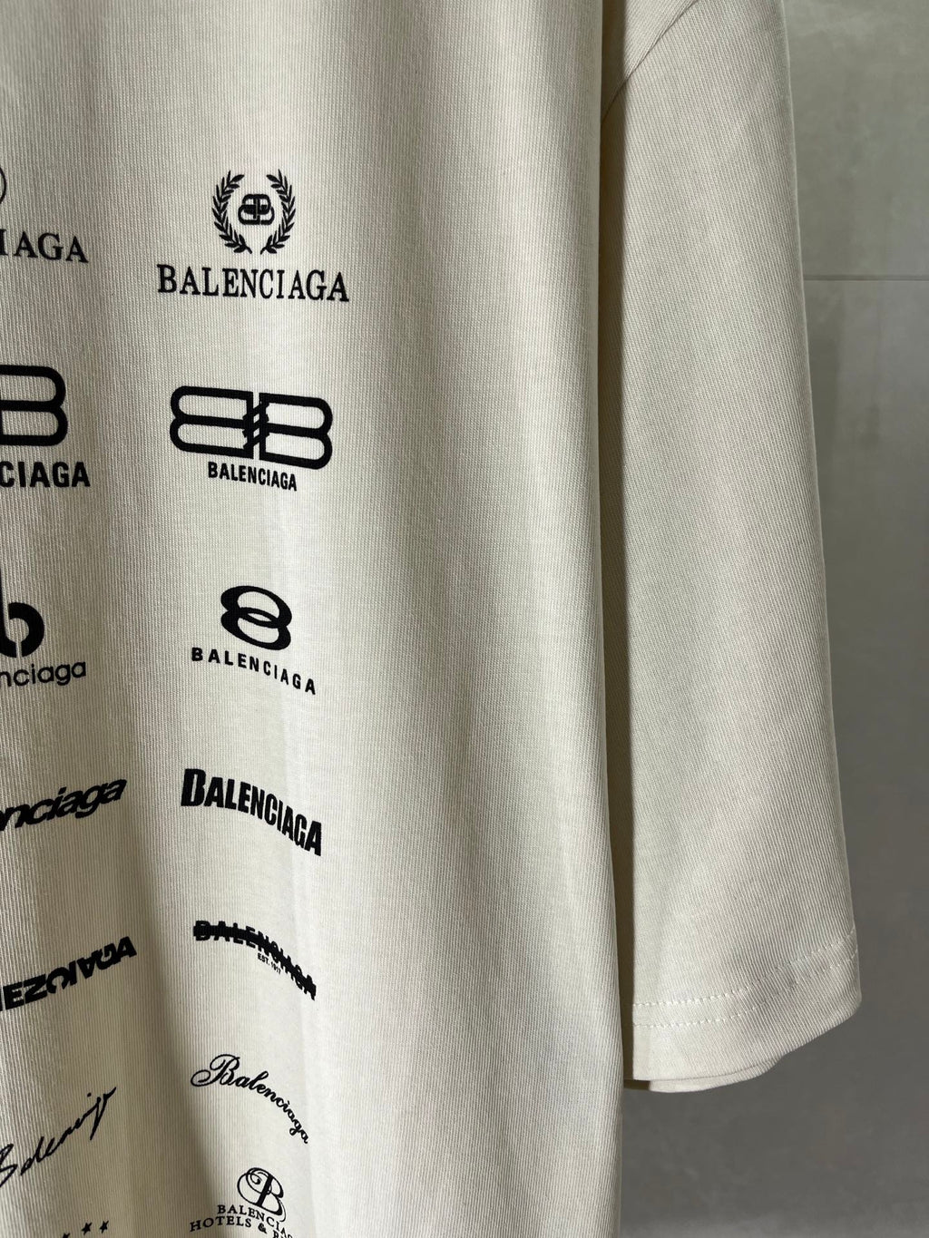 White T-shirt sleeve print with Balenciaga logos and small script details
