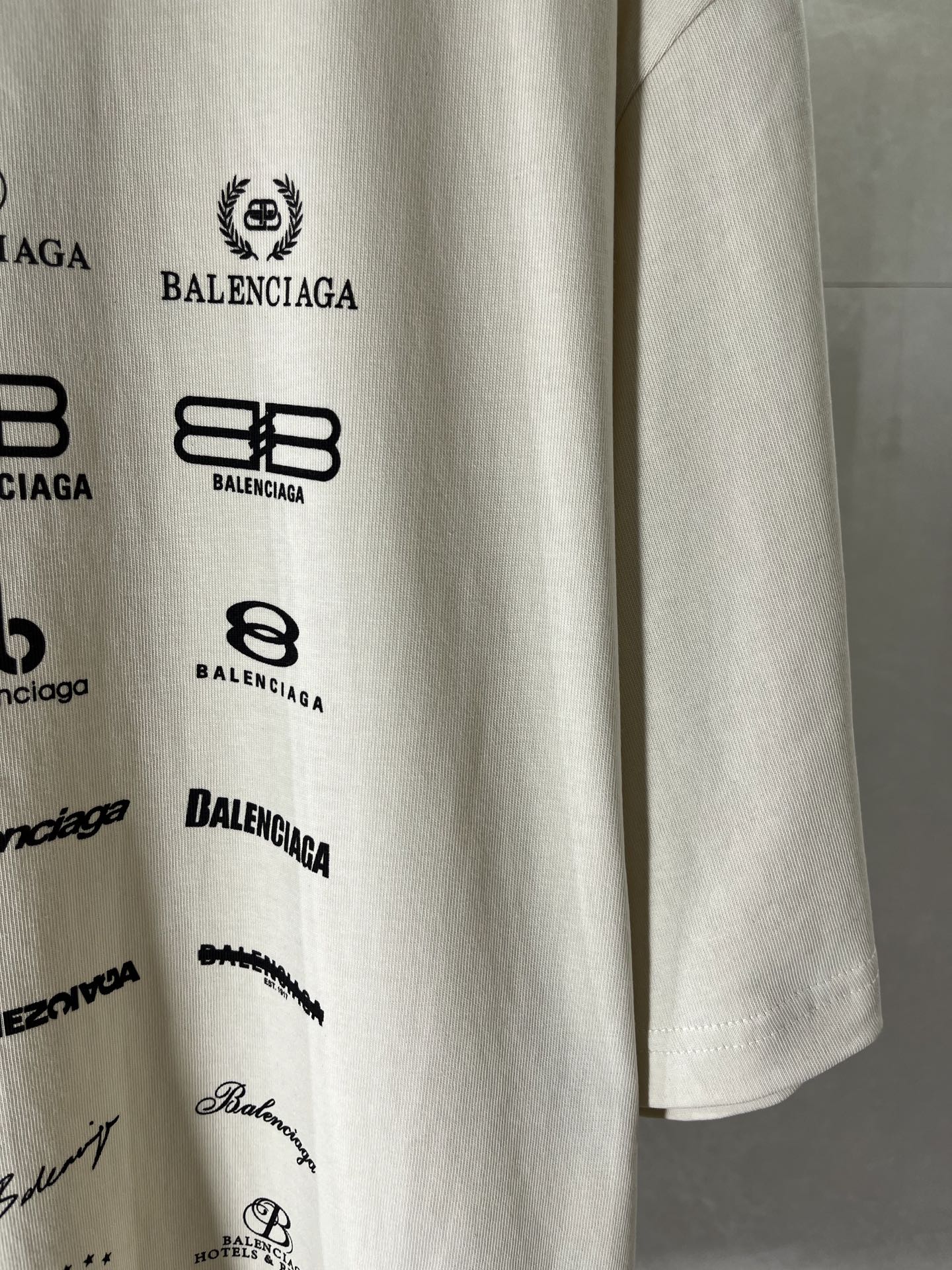 White T-shirt sleeve print with Balenciaga logos and small script details