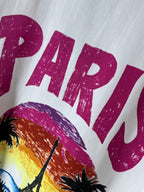 Balenciaga T-shirt close-up: magenta “PARIS” text above palm tree graphic
