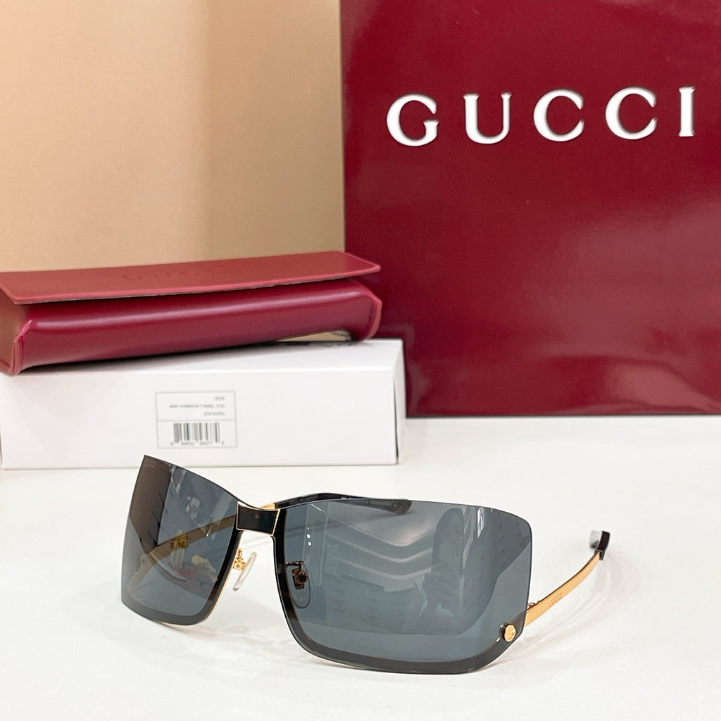 Gucci glasses with dark-tinted lenses, black frame, and gold-tone accents