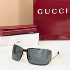 Gucci glasses with dark-tinted lenses, black frame, and gold-tone accents