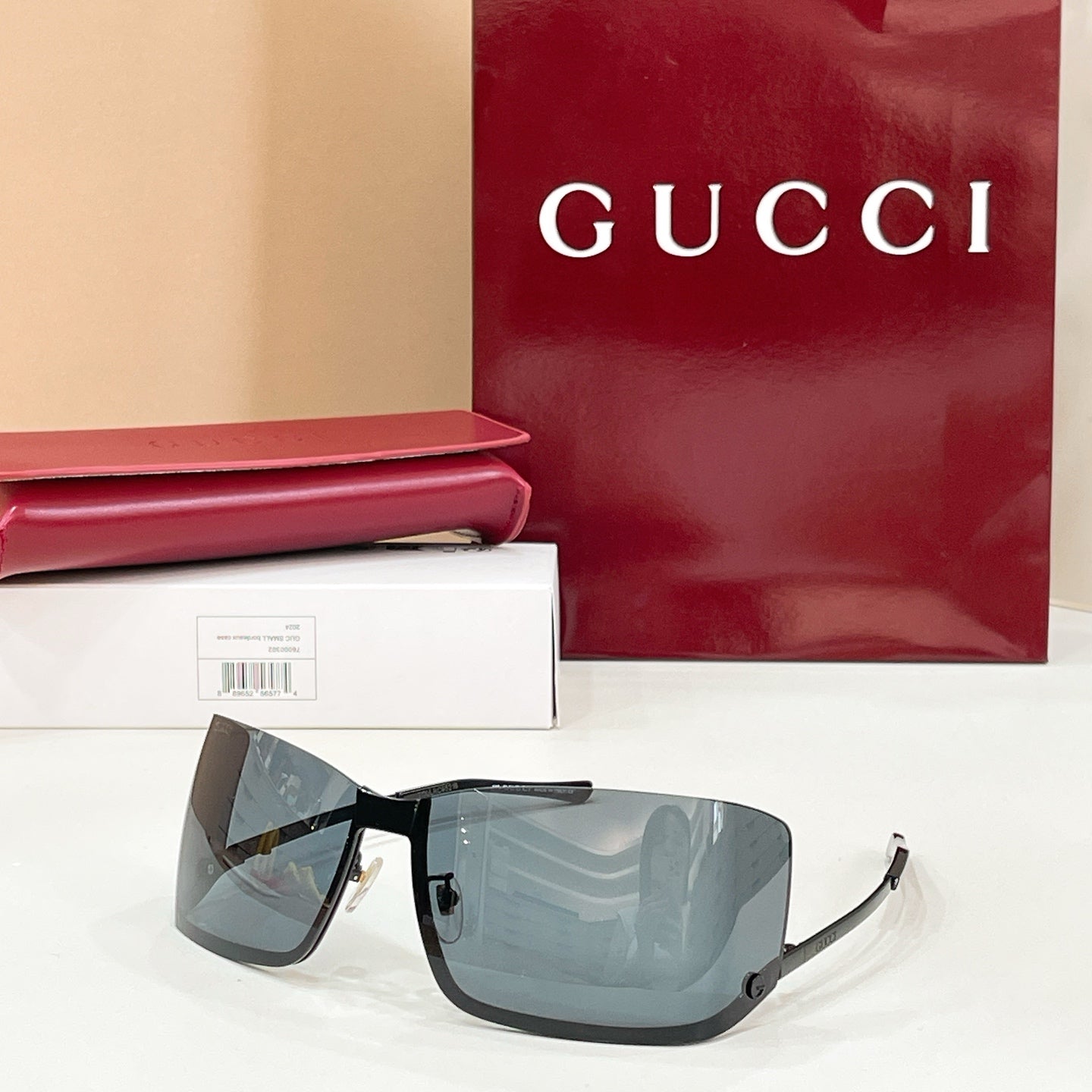 Gucci glasses with blue-gray tinted lenses, black frame, and gold-tone details