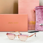 MiuMiu cat-eye glasses, pale pink-tinted lenses with gold frames and blue-tipped temples