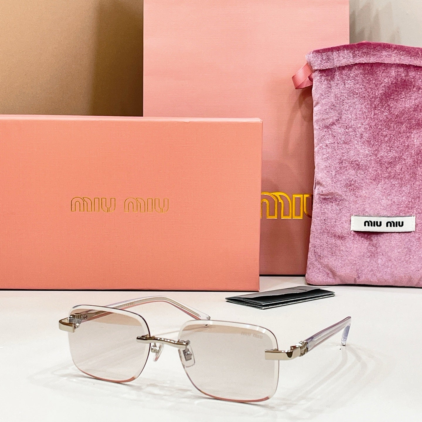 Sunglasses with clear frame and lightly tinted lenses with gold metal temples