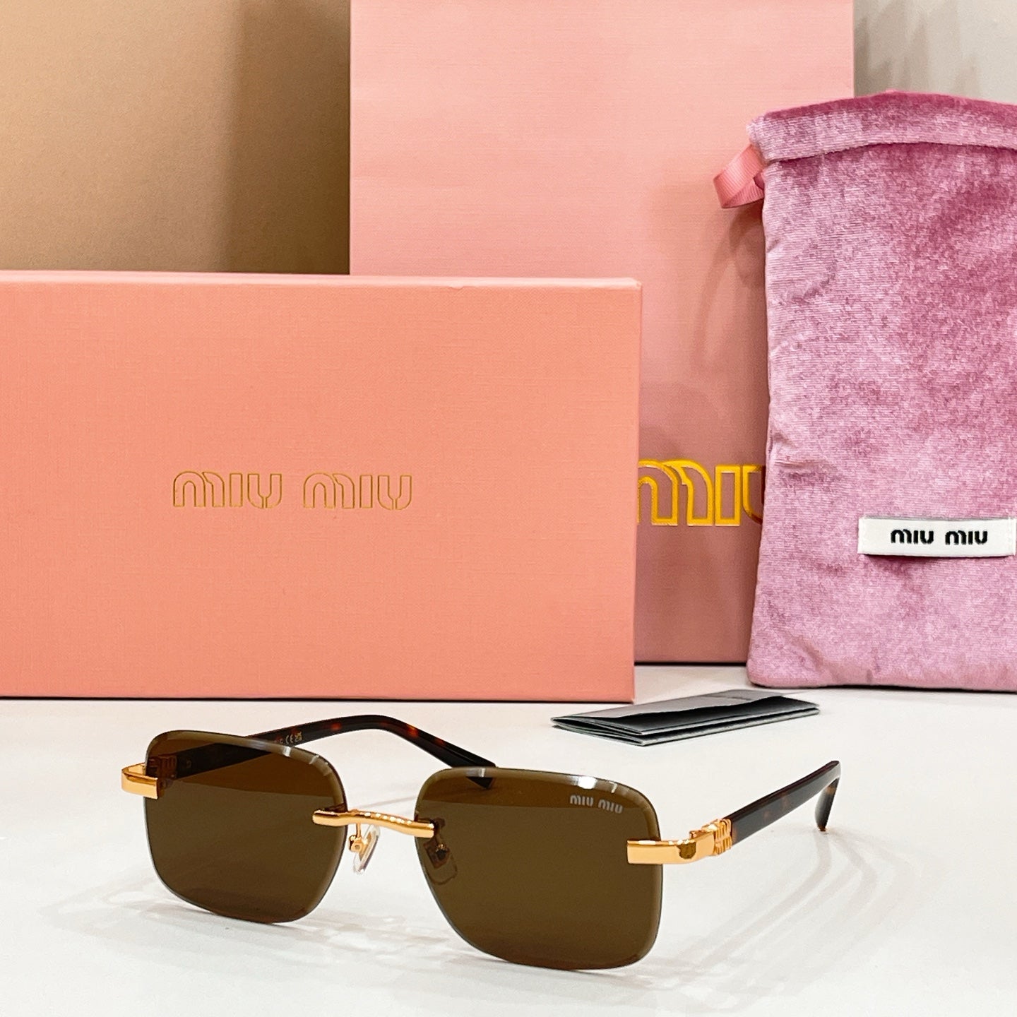 Sunglasses with dark brown lenses and gold metal frame and temples