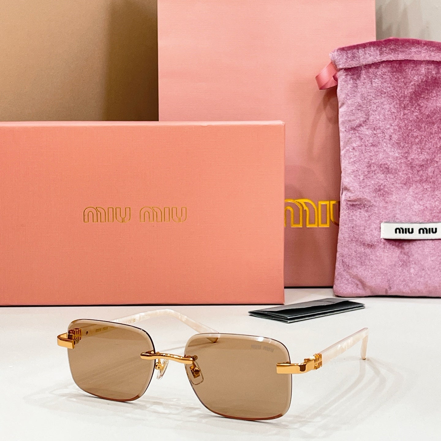 Sunglasses with tan-tinted lenses and gold metal frame and temples