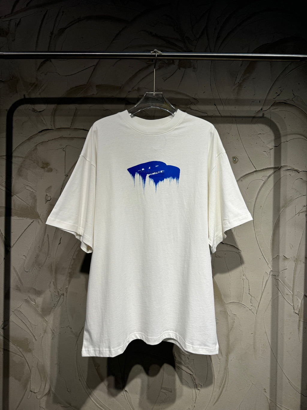 White Balenciaga T-shirt with blue drip logo graphic, short sleeves, crew neck