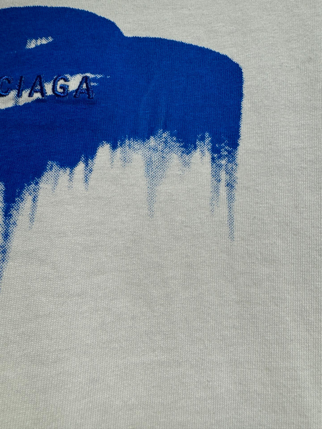 White Balenciaga T-shirt with blue drip logo area on knit fabric