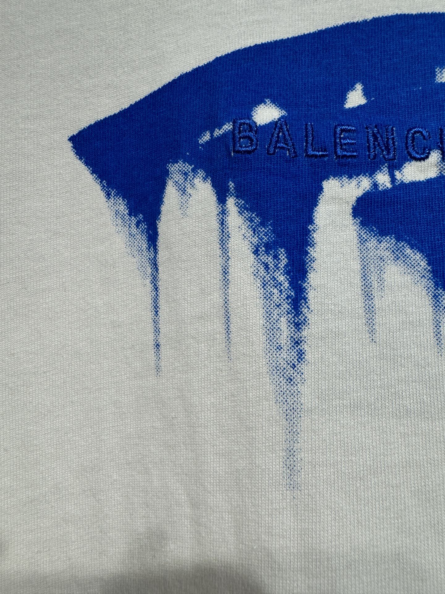 White Balenciaga T-shirt with blue drip logo pattern detail on knit fabric