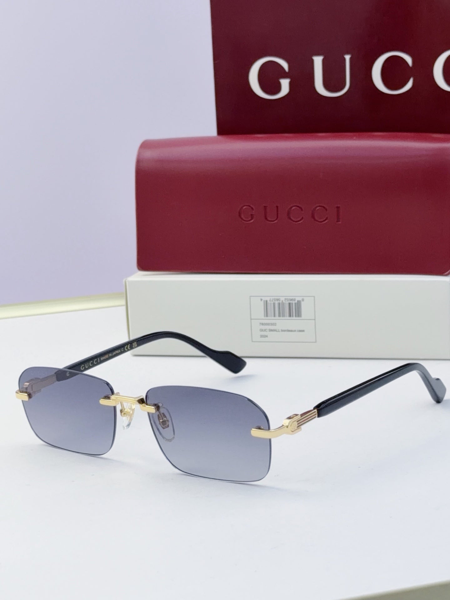Gucci sunglasses with blue mirrored lenses, black temples, gold-tone metal bridge