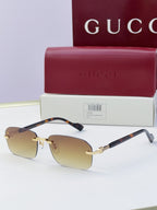 Gucci sunglasses with light brown lenses, tortoiseshell temples, gold-tone metal details