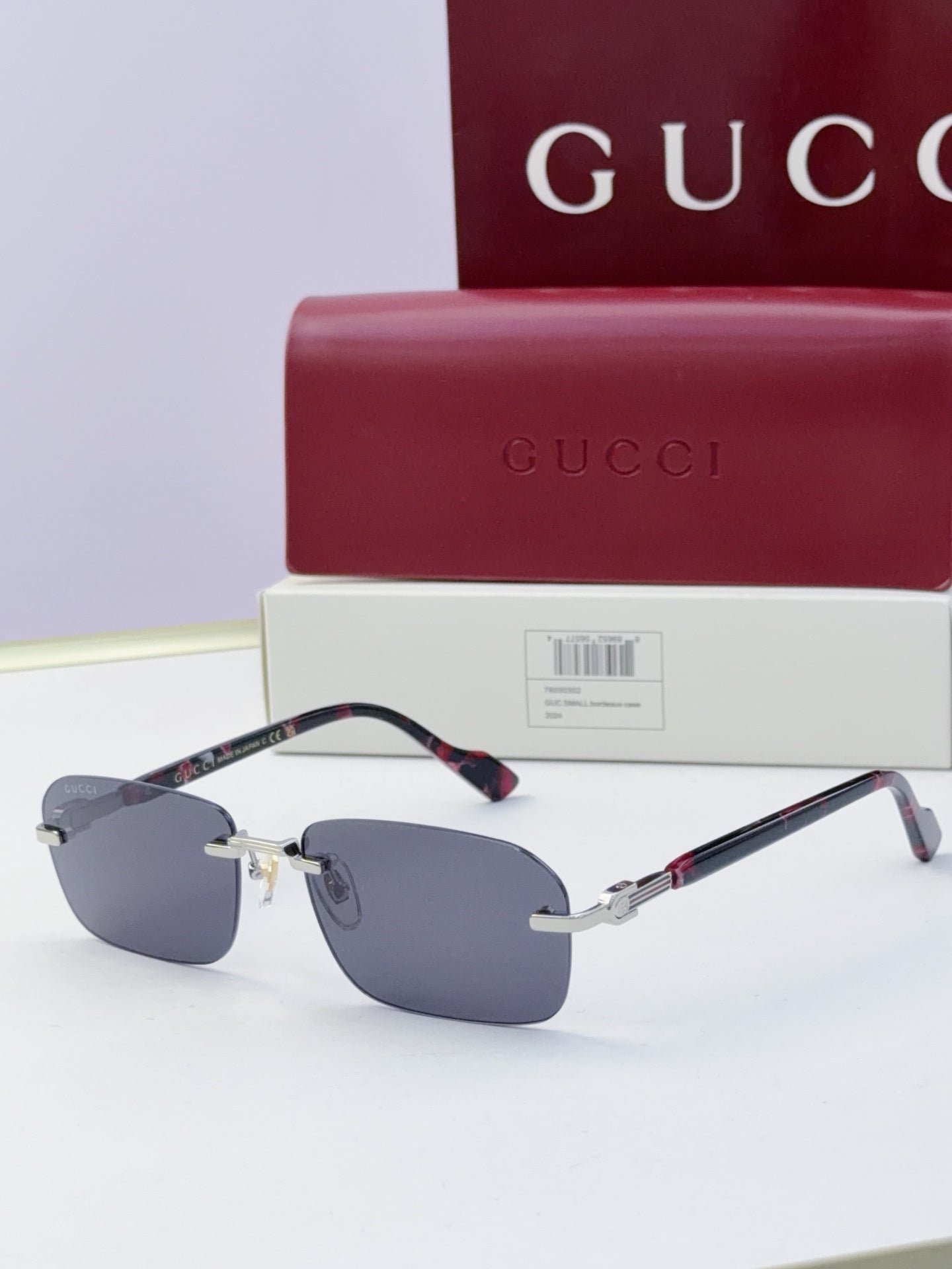 Gucci sunglasses with blue mirrored lenses and tortoiseshell temple accents, gold-tone hardware