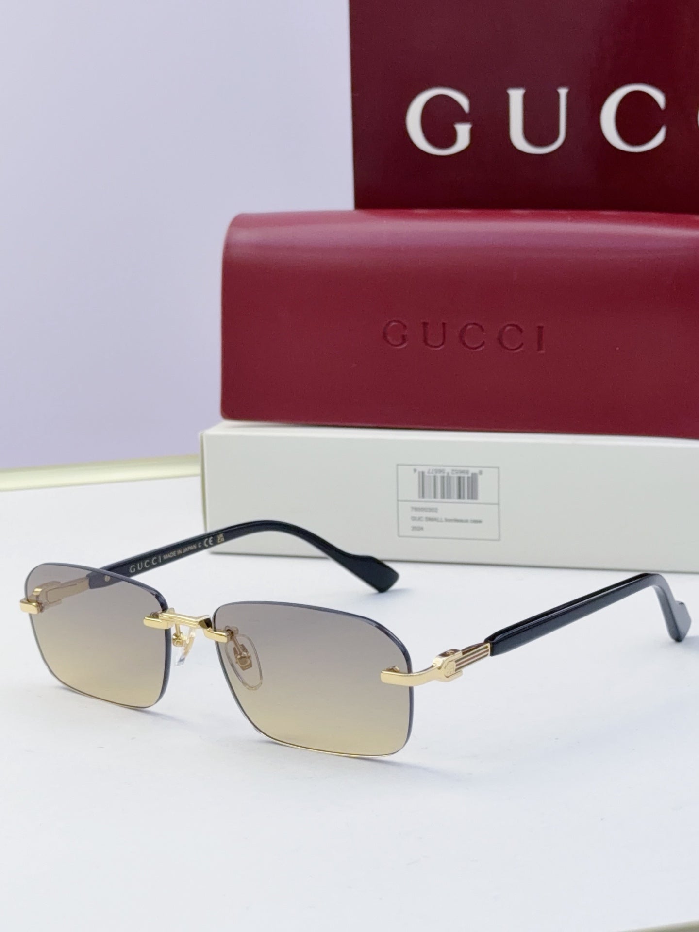 Gucci sunglasses with clear smoke lenses, black temples, gold-tone metal bridge