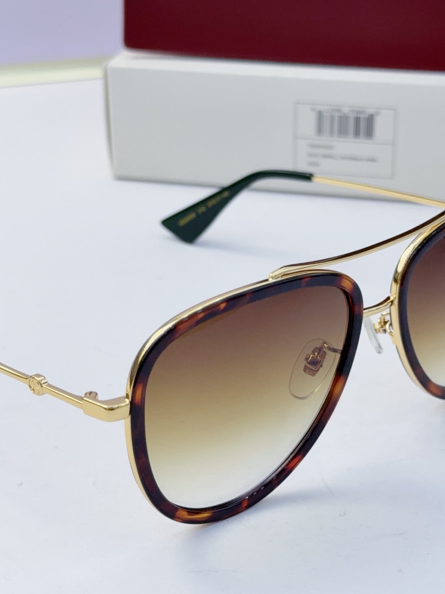 Gucci glasses with amber lenses and gold metal frames, side view with temples