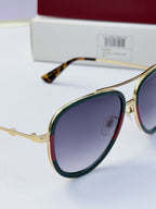 Gucci glasses with dark purple lenses and gold metal frames, close side view
