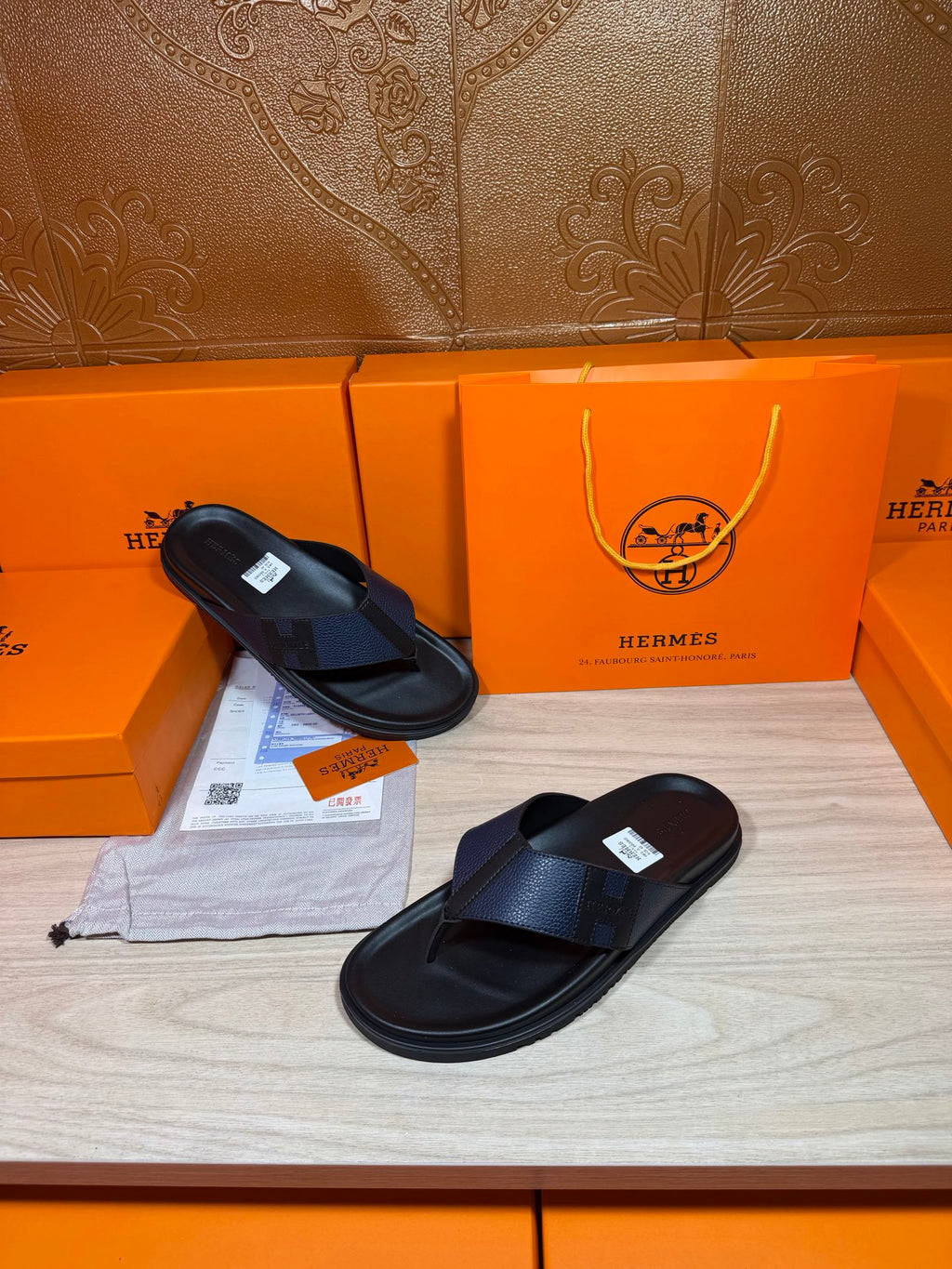 Black slide sandals with textured straps, one sandal resting on the other